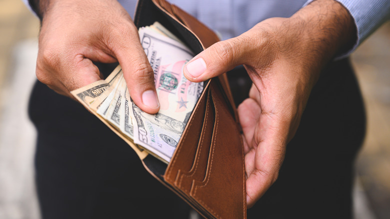 Man with wallet of cash