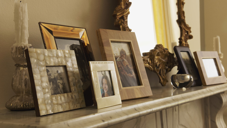 cluttered mantel with picture frames