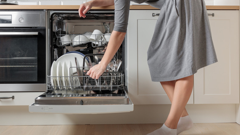 Person loading a dishwasher