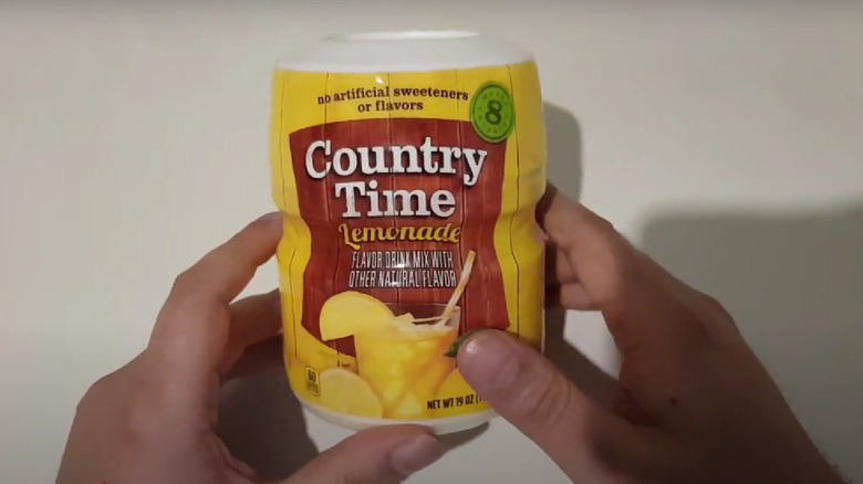 holding box of lemonade powder 