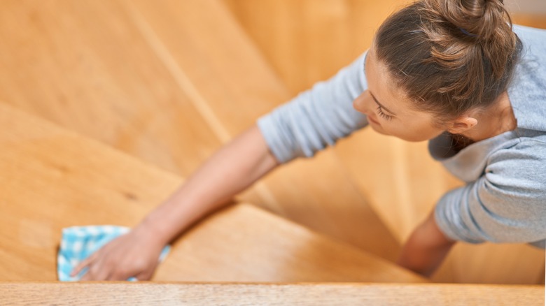 Woman wiping stair steps