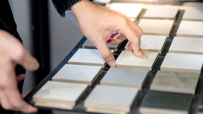 A designer choosing tile swatches.