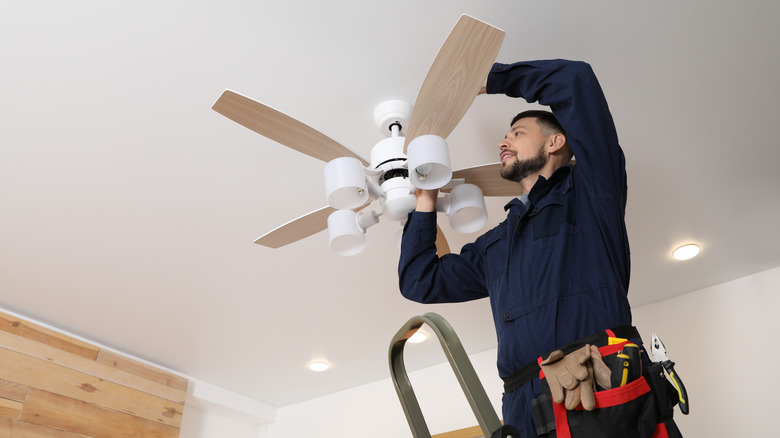 Man installing a ceiling fan