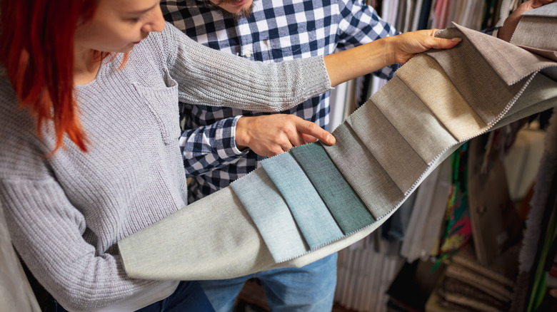 Couple viewing upholstery samples