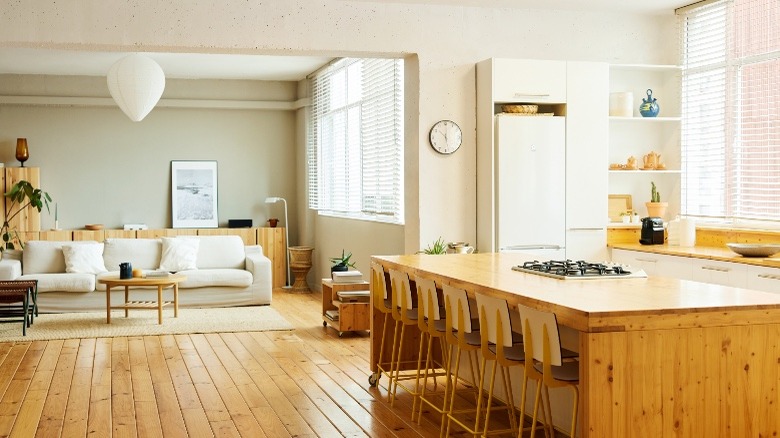 Open concept living area with warm wood floors and furniture