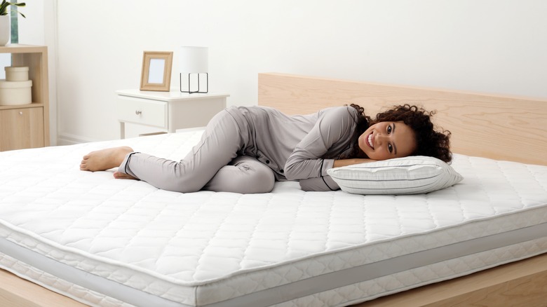 Woman laying on mattress