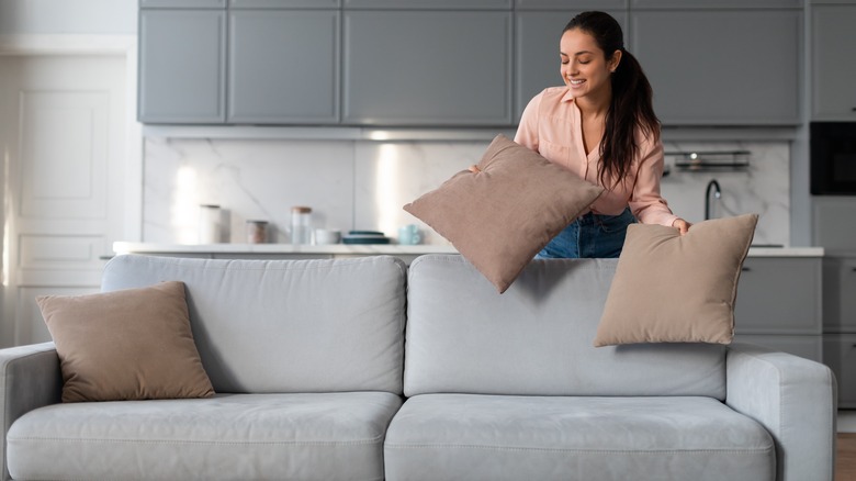 Woman arranging pillows