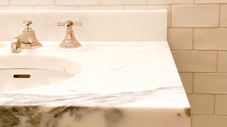 close-up of white bathroom countertop with black veins