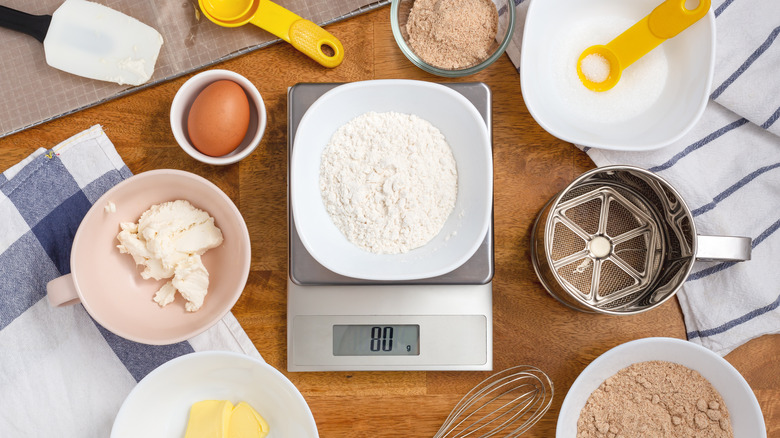 Kitchen scale surrounded by ingredients