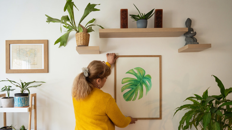 Woman decorating an accent wall