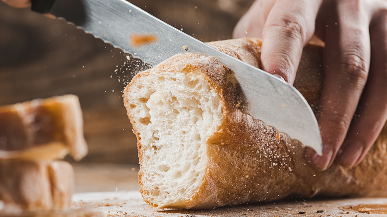 Person cutting bread