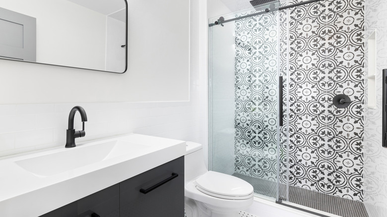 A bathroom with sliding glass shower doors