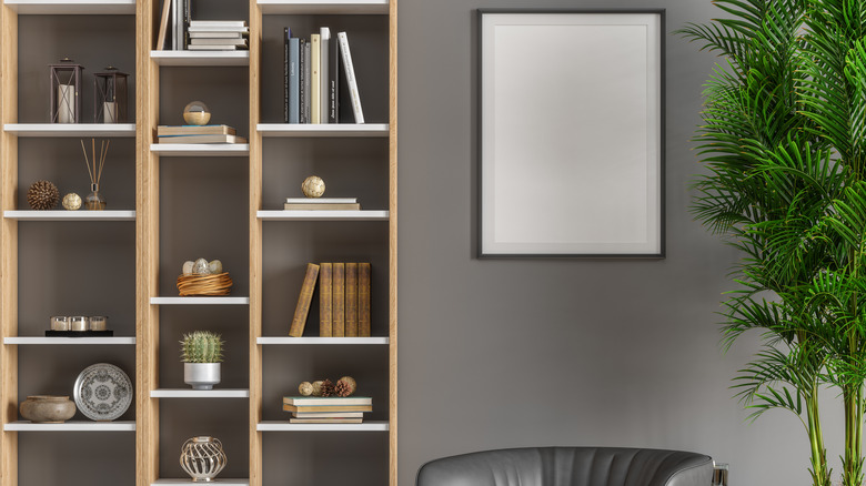 Light wood bookshelf with several shelves of books in varying positions