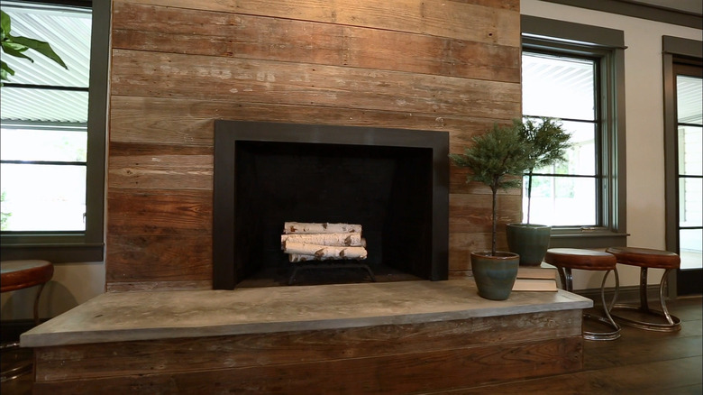 Reclaimed wood surrounds fireplace