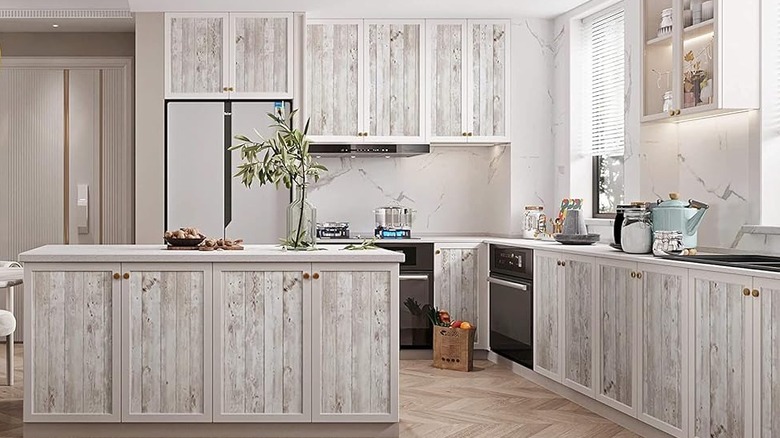 A bright, rustic kitchen with light gray shiplap cabinets