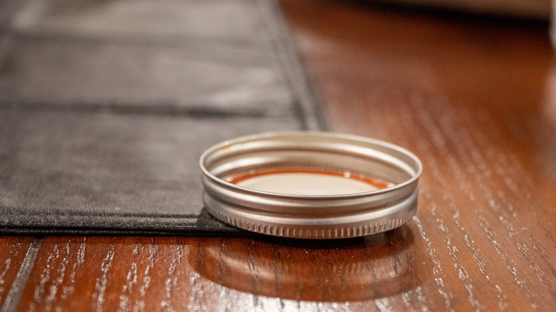 A Mason jar lid sitting on a table