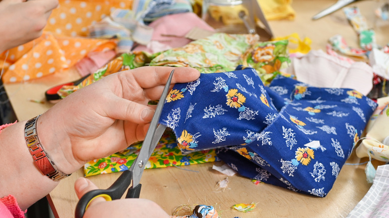 Person cutting fabric scraps