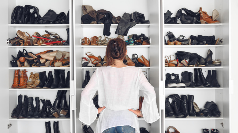 Woman examining shelves of shoes