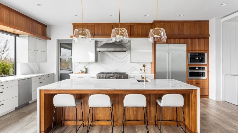 White kitchen cabinets brown accents 