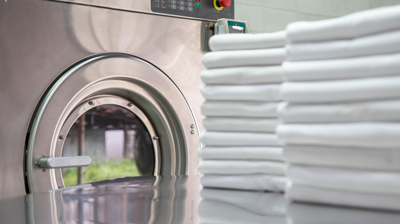 white sheets next to washing machine