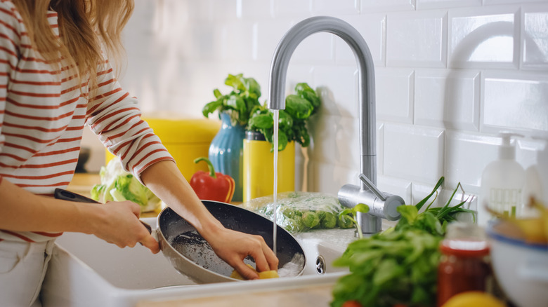 Woman washing pan