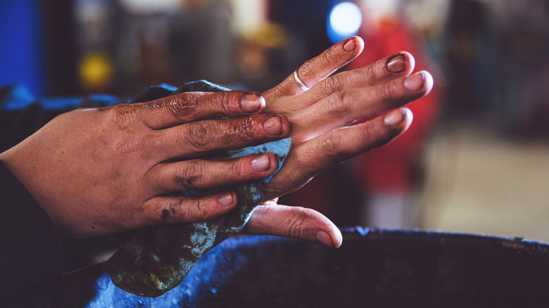 Woman cleaning greasy hands