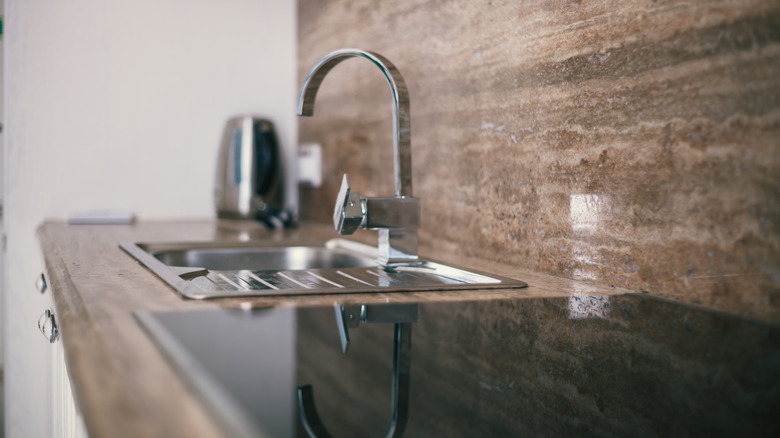 sink with marble backsplash