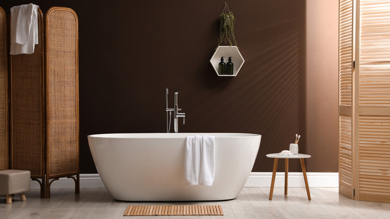 Bathroom with brown walls and wooden accents