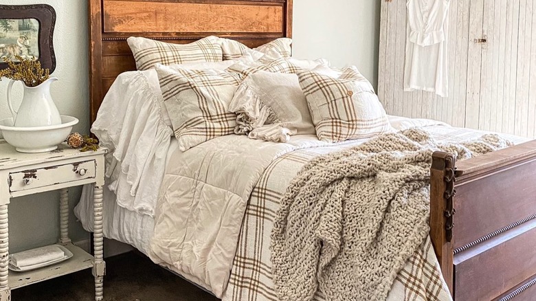 Brown and white plaid bedding on bed.