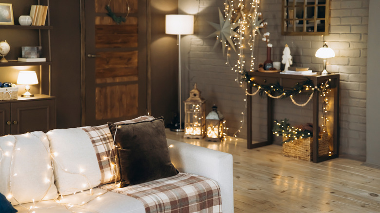 Sofa with brown and white plaid throw blanket.