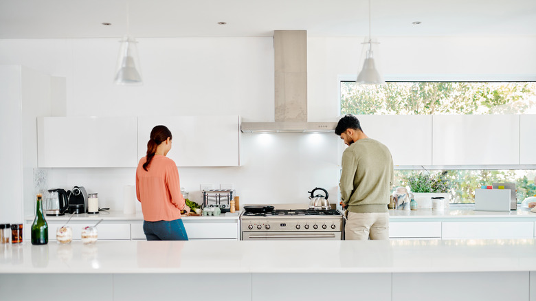 couple cooking in large white kitchen