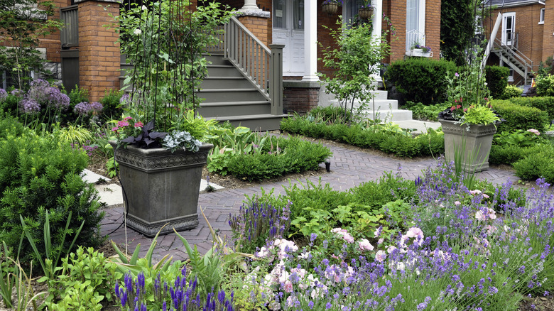 A fairly high-maintenance garden with lots of flower beds and hedges