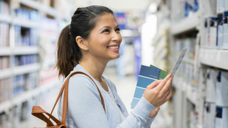 woman shopping in paint aisle