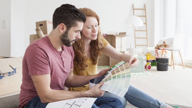 Couple looking at color swatches in new home