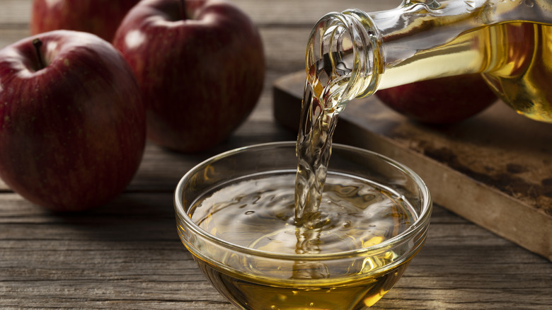 Pouring apple cider vinegar