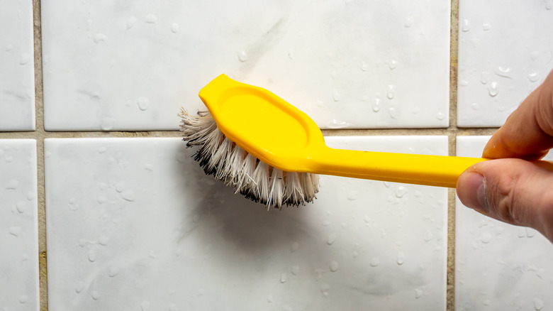 cleaning grout with yellow brush