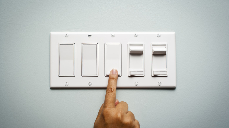 person touching lightswitch