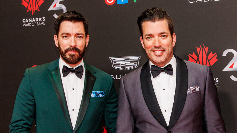 The Property Brothers posing while wearing tuxedos