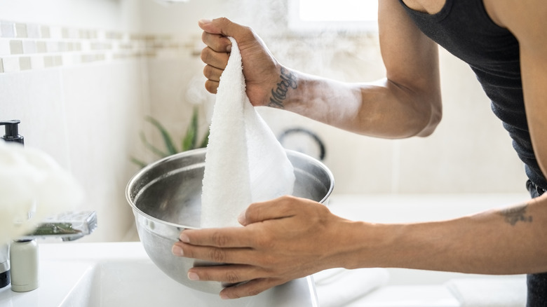 Putting white towel into wash