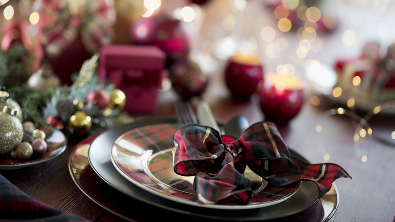 Holiday table setting with a plaid-patterned bow