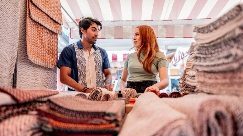 A man and woman shopping for carpet