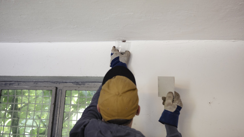 Man catching spider to release