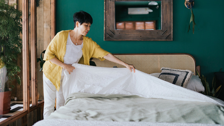 woman making bed