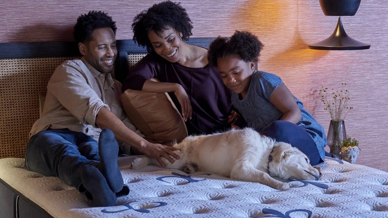 family sitting on mattress