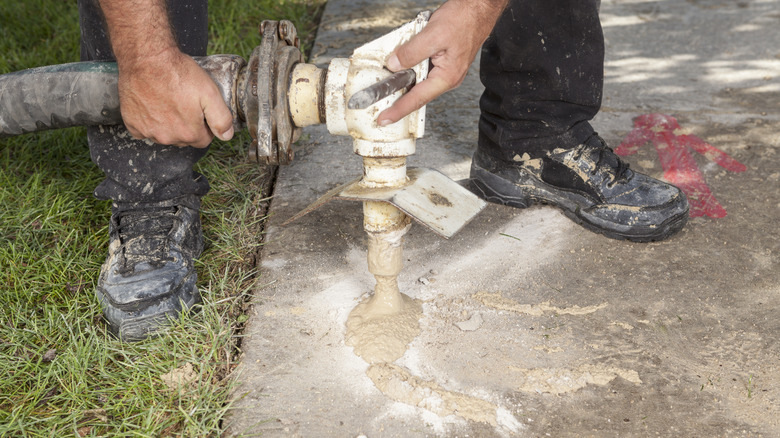 Worker leveling concrete