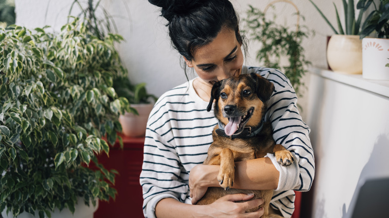 Woman with plants and dog