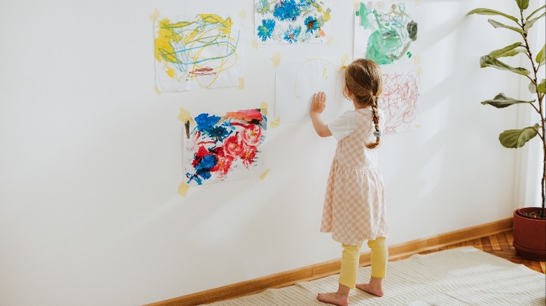 girl displaying her artworks