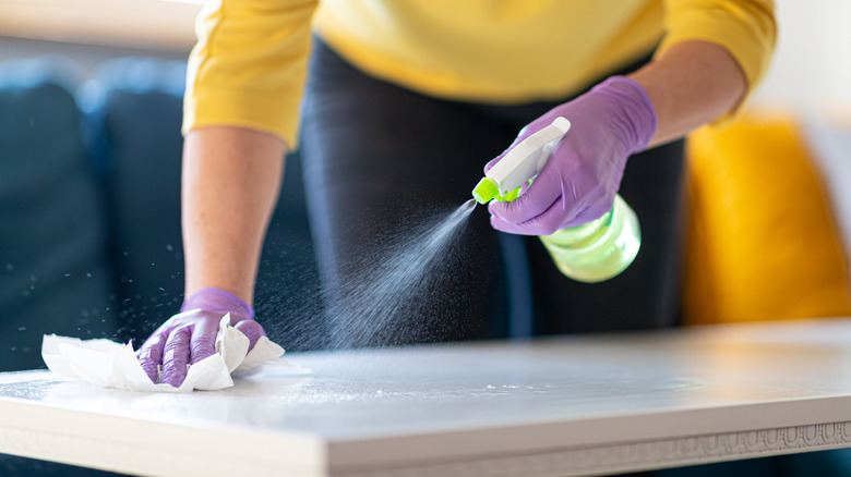 Woman spraying table