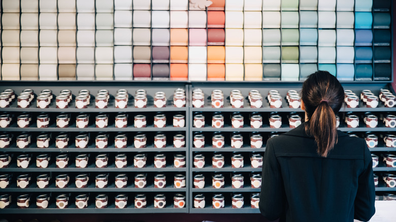 Woman picking paint colors and finishes at the store