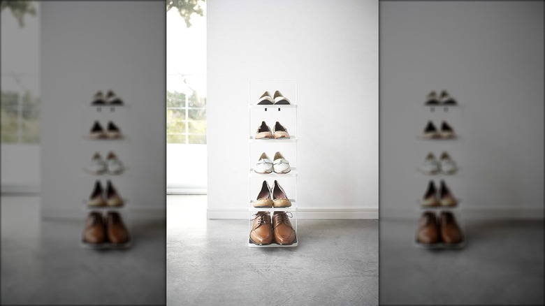 Yamazaki shoe rack with 5 pairs of shoes on it in a house with white walls